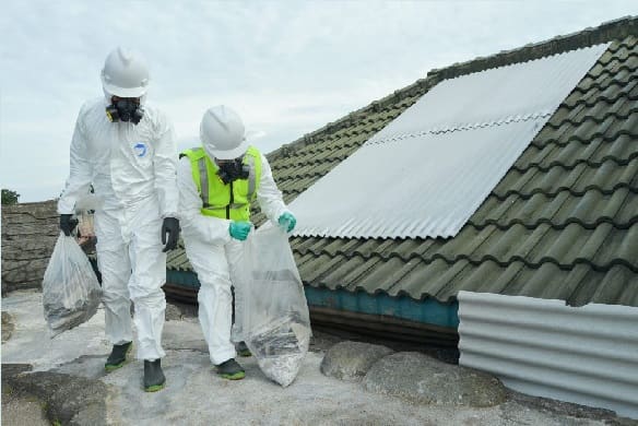 Asbestos removal worker in protective equipment