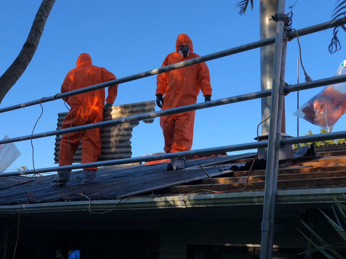 JP Franklin asbestos removal crew in protective suits removing an asbestos roof in Auckland
