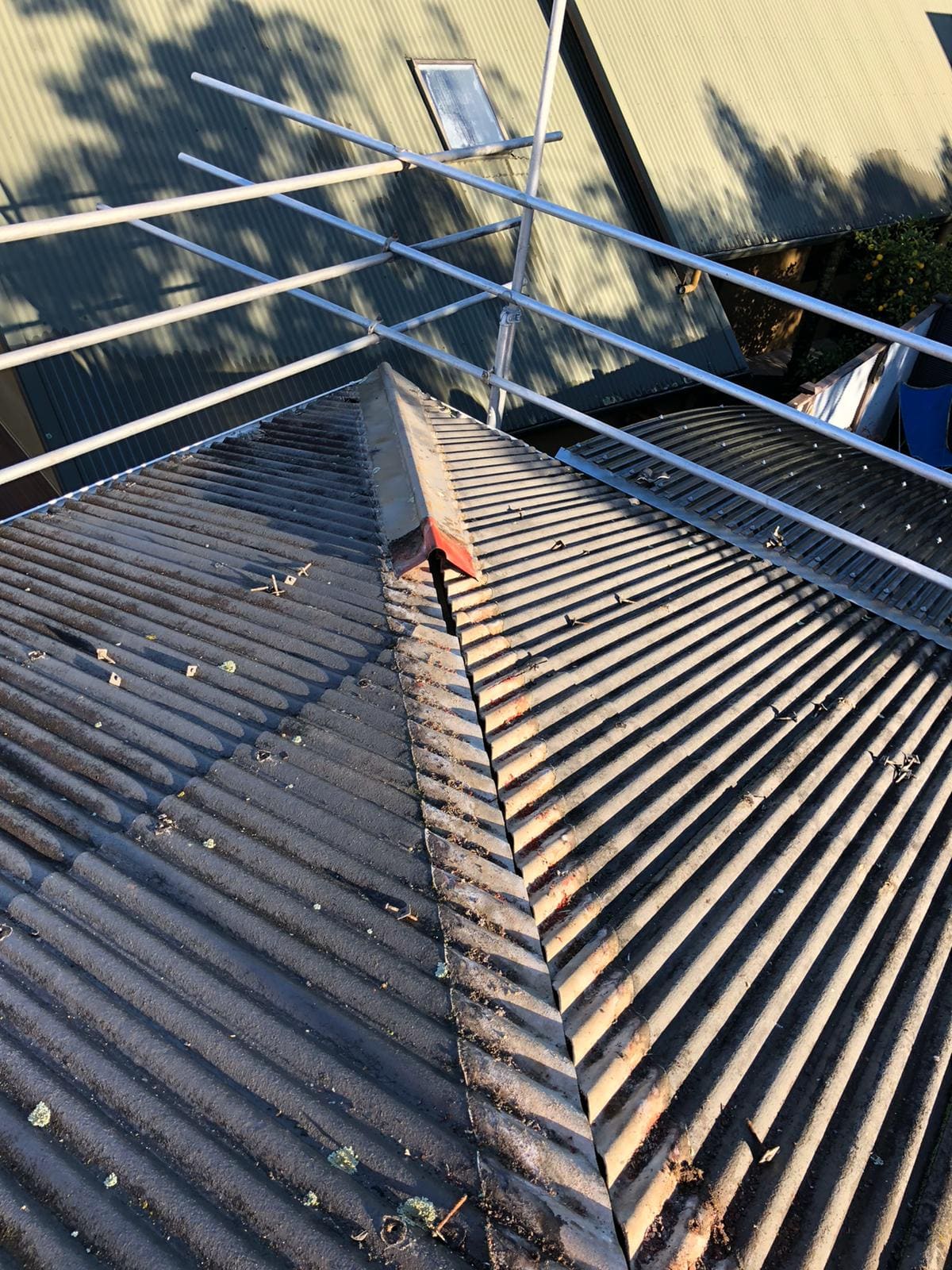 Asbestos roofing sheets being removed