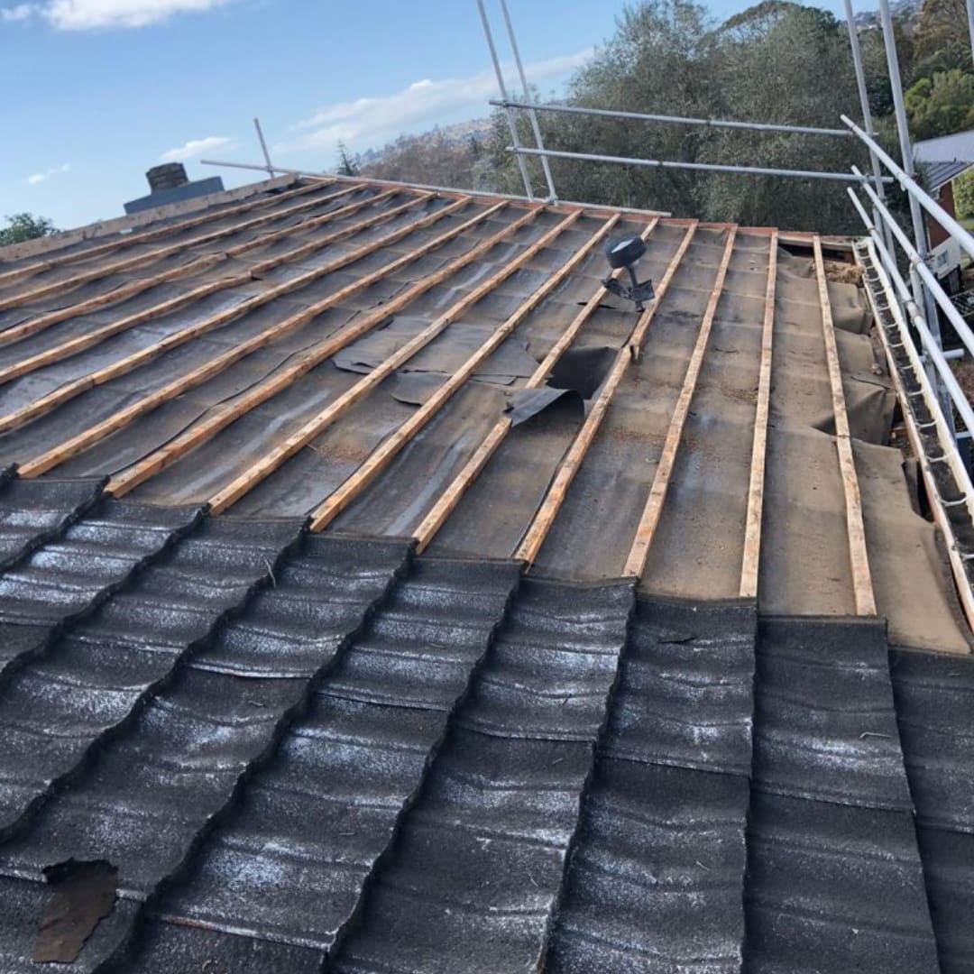 Partially stripped asbestos roof during removal