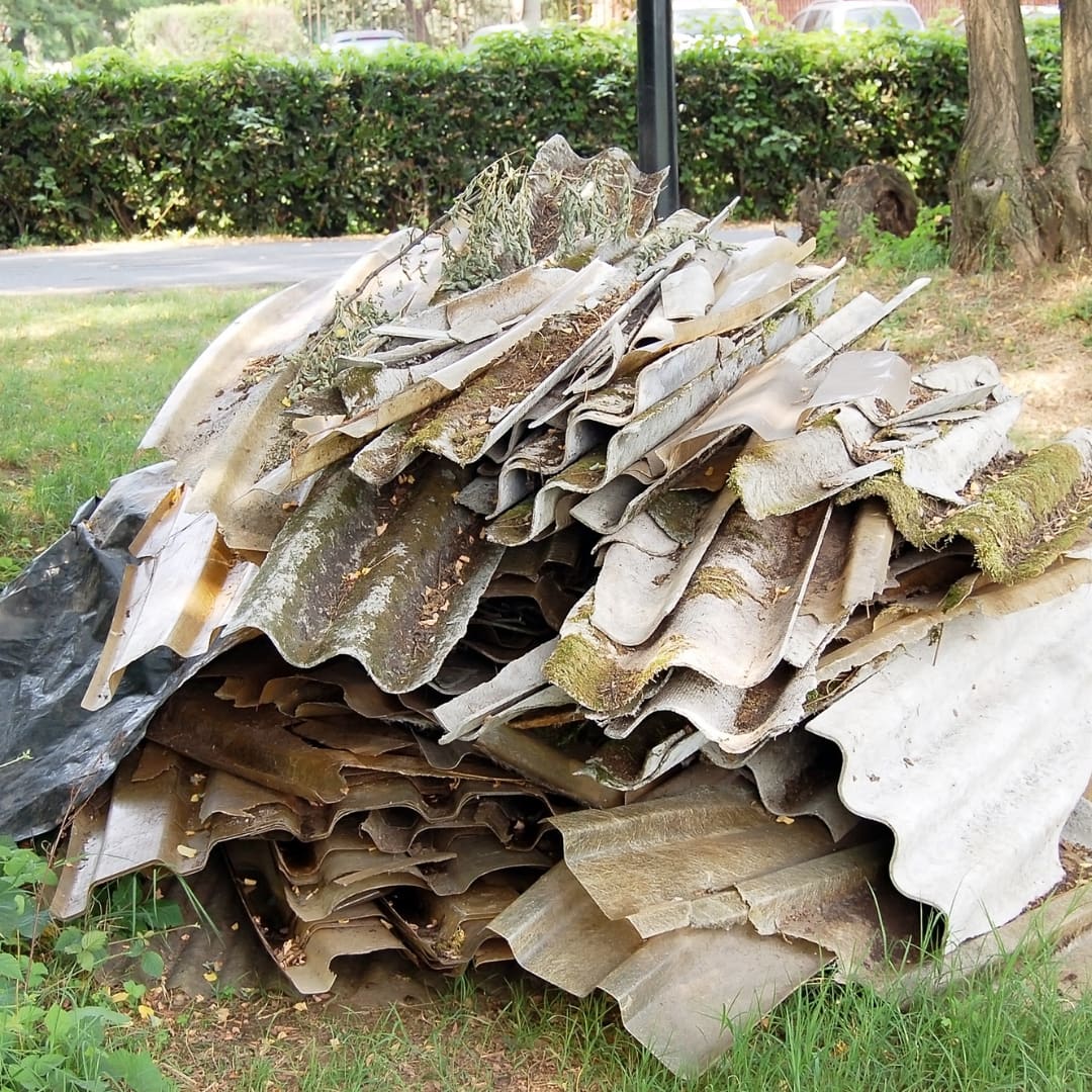 Broken Super Six asbestos sheeting on the ground contaminating the soil